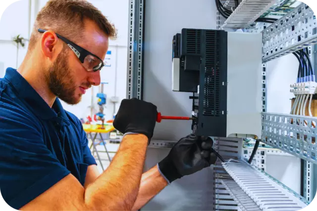 Technician inspecting explosion-protected electrical equipment.